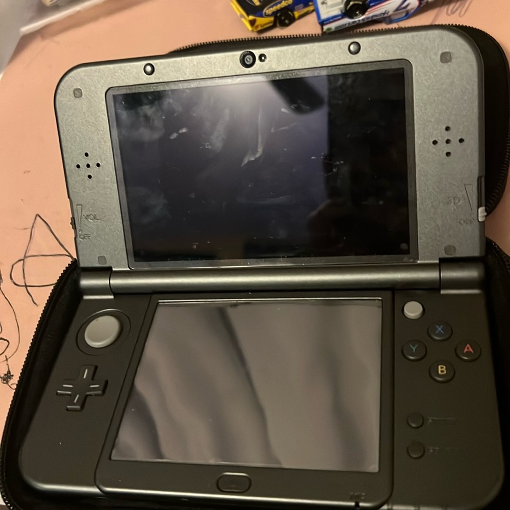 Nintendo 3DS XL with sonic game included and Mario case.